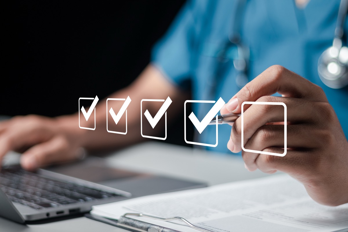 Healthcare professional reviewing charts